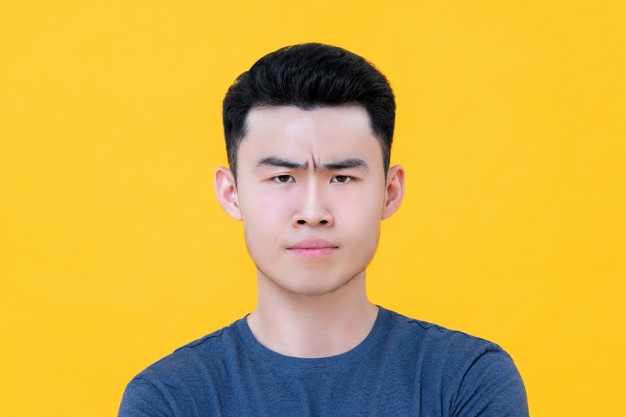 close up unhappy angry young asian man face 8087 4009